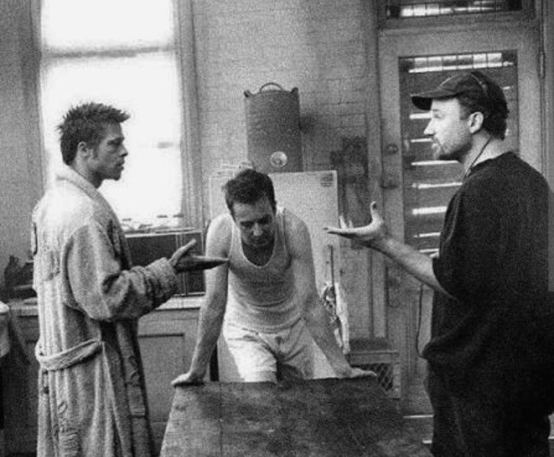 Fight Club 1999 kitchen scene with Tyler Durden and the Narrator discussing identity and control in a dimly lit apartment